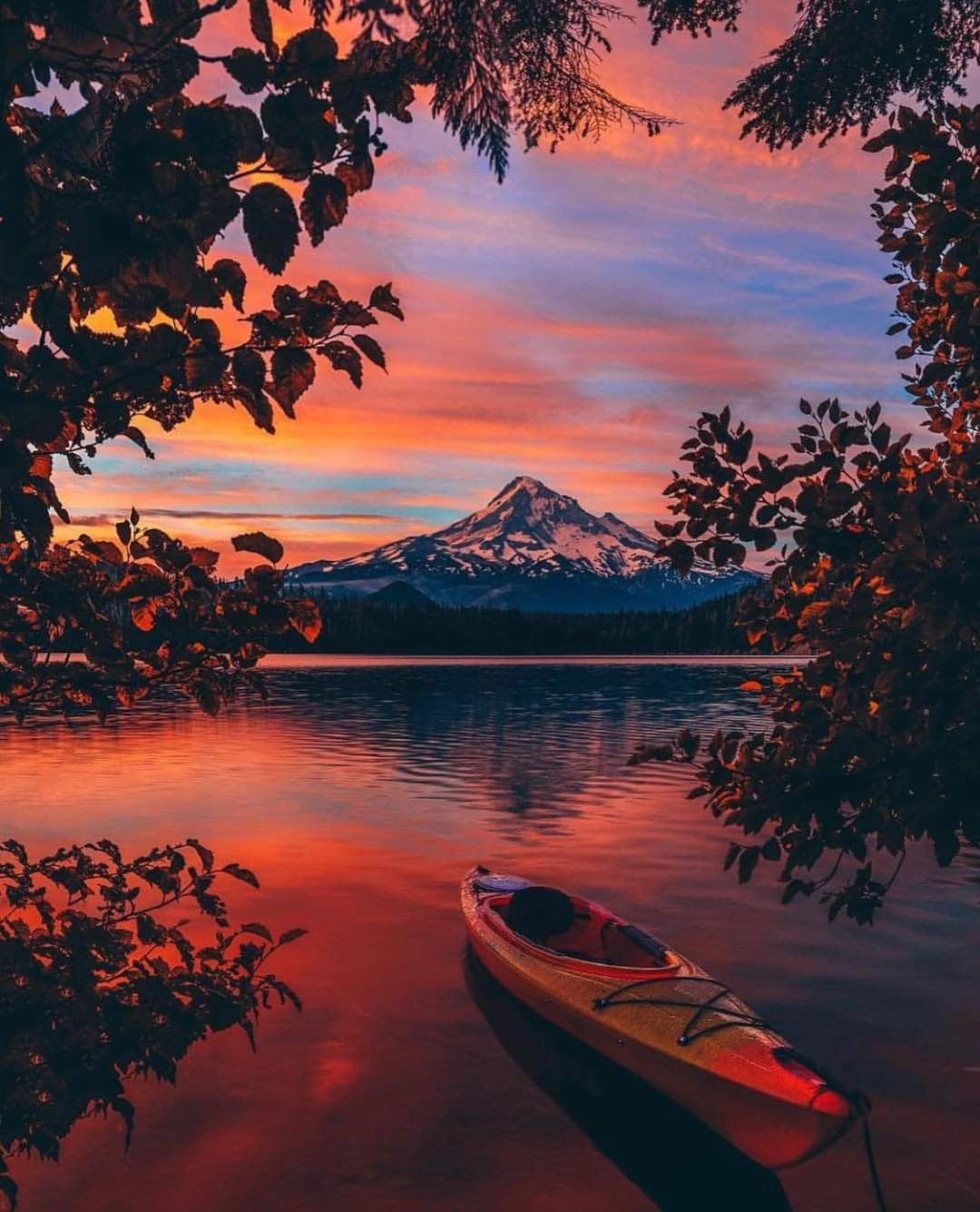 A painting of a boat on the water at sunset.