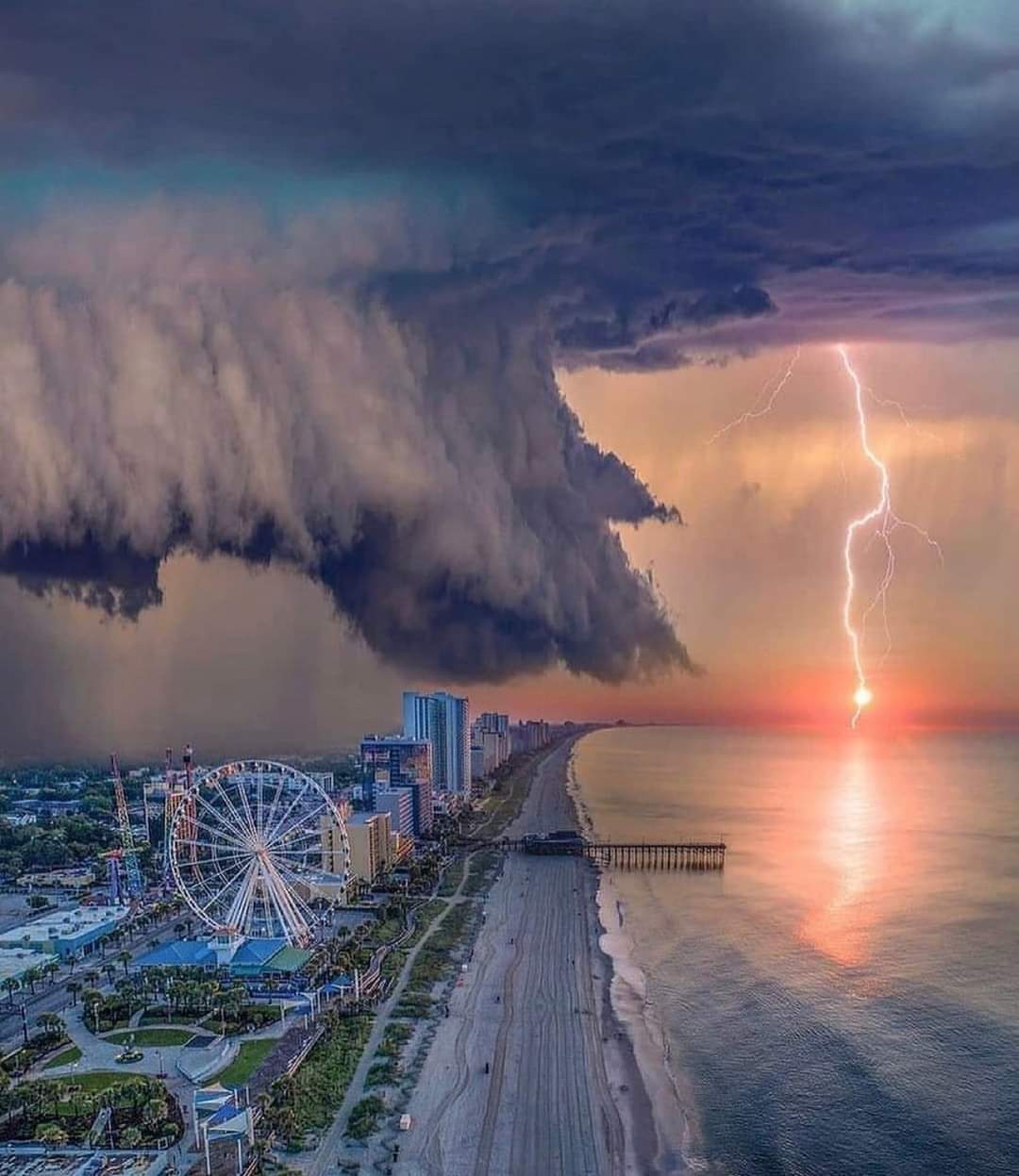 A storm is coming in the sky over the ocean.